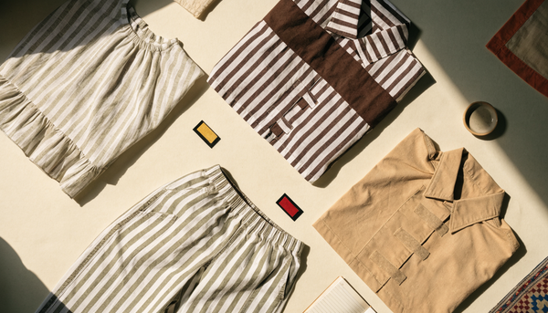 Adaptive clothing items flat lay — front-open nighty, velcro shirts and loose pants
