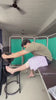 Physiotherapist demonstrating Aasra side-opening velcro pyjamas on a patient