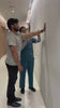 Clinician demonstrating Aasra side-opening velcro t-shirt on a patient